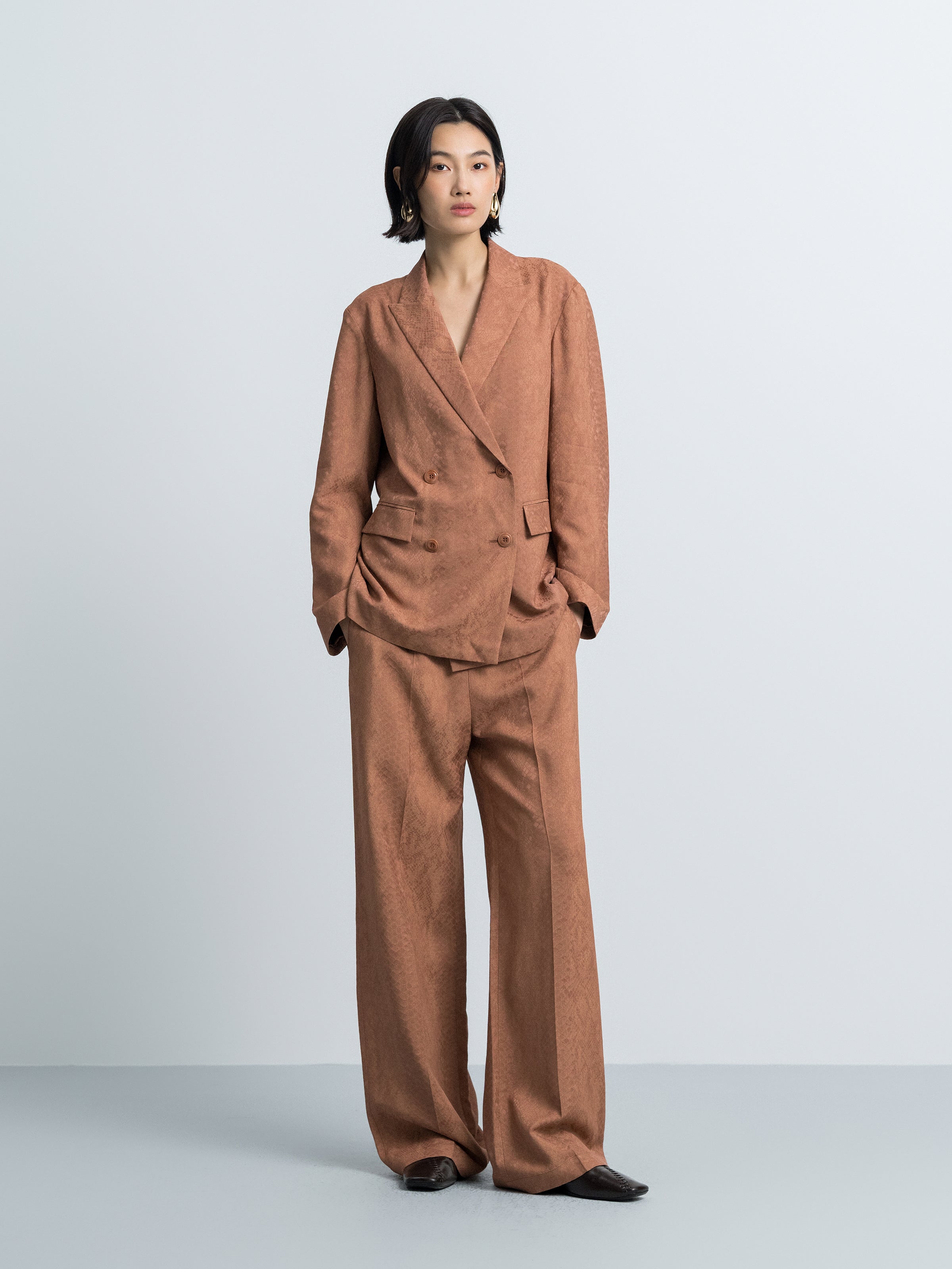 Nude straight-fit blazer with notch lapels, two-button front, flap pockets