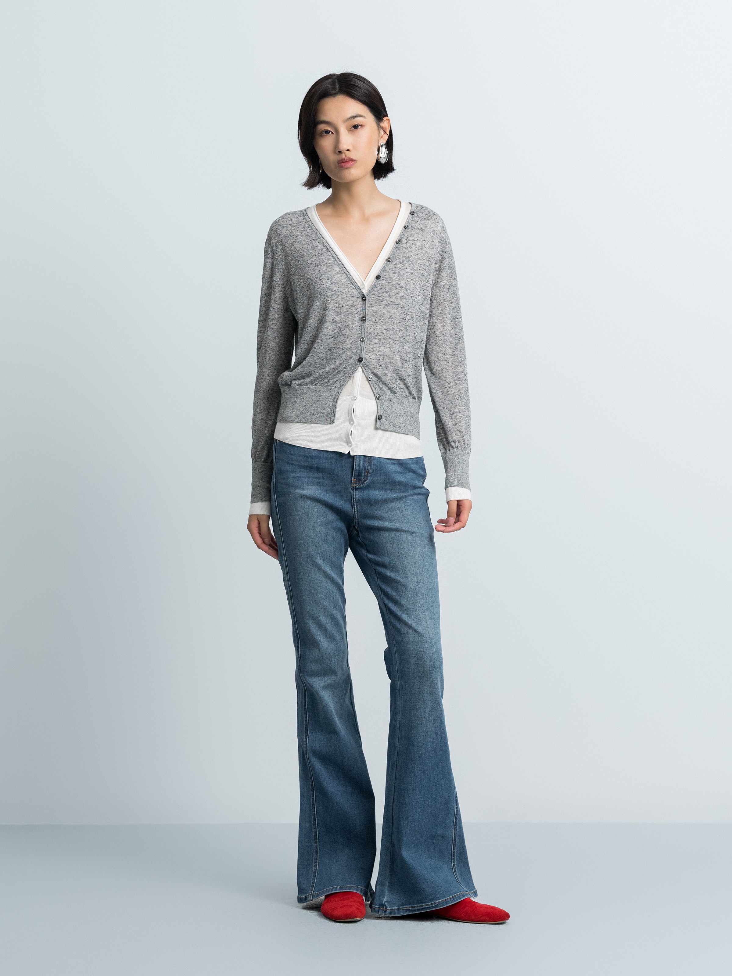 Grey knit V-neck button cardigan with contrast cream inner layer hemline