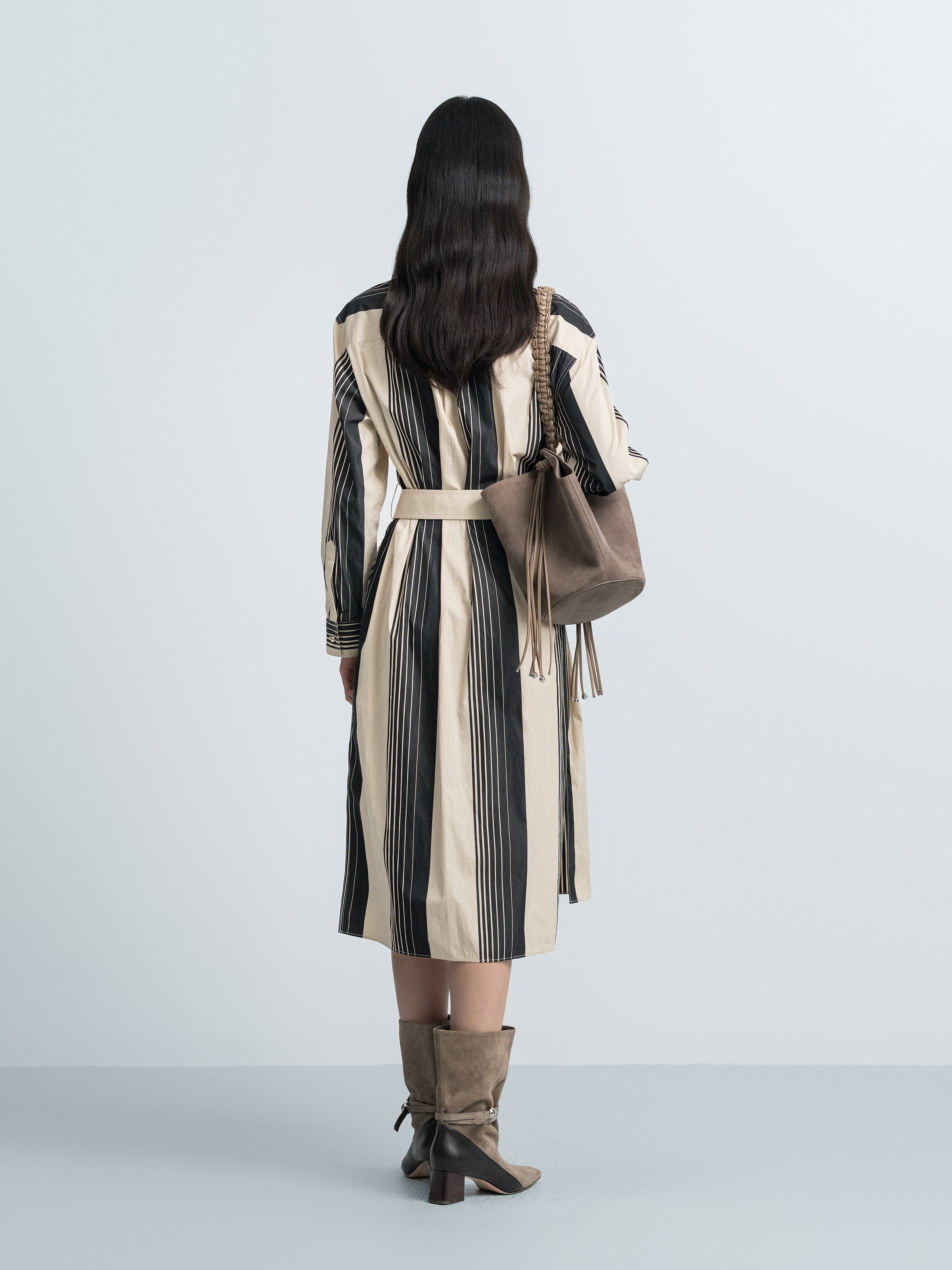 Back view striped trench coat with stand collar and belted waist, vertical black and cream