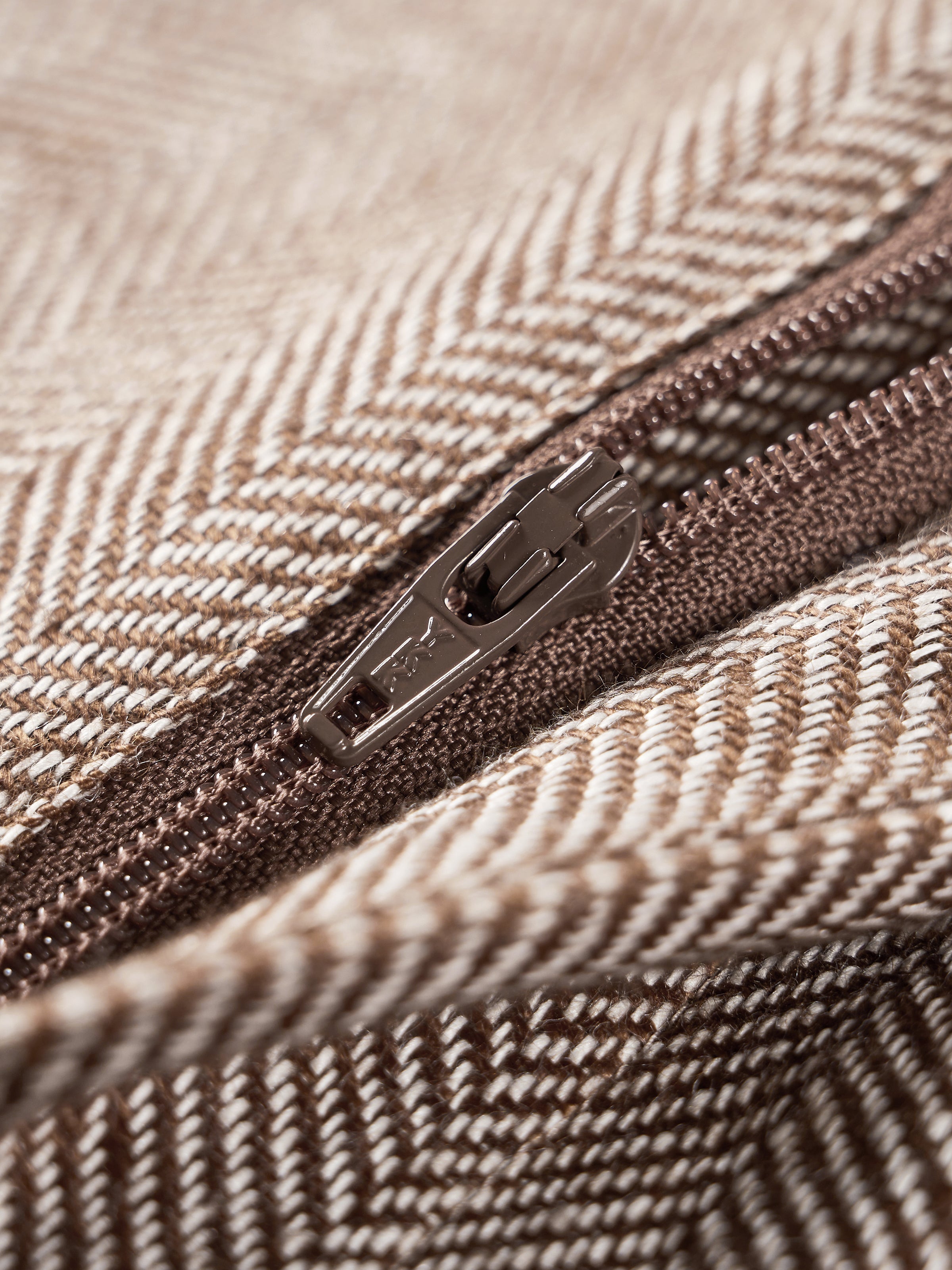Coffee brown trouser zipper close-up on the front fly