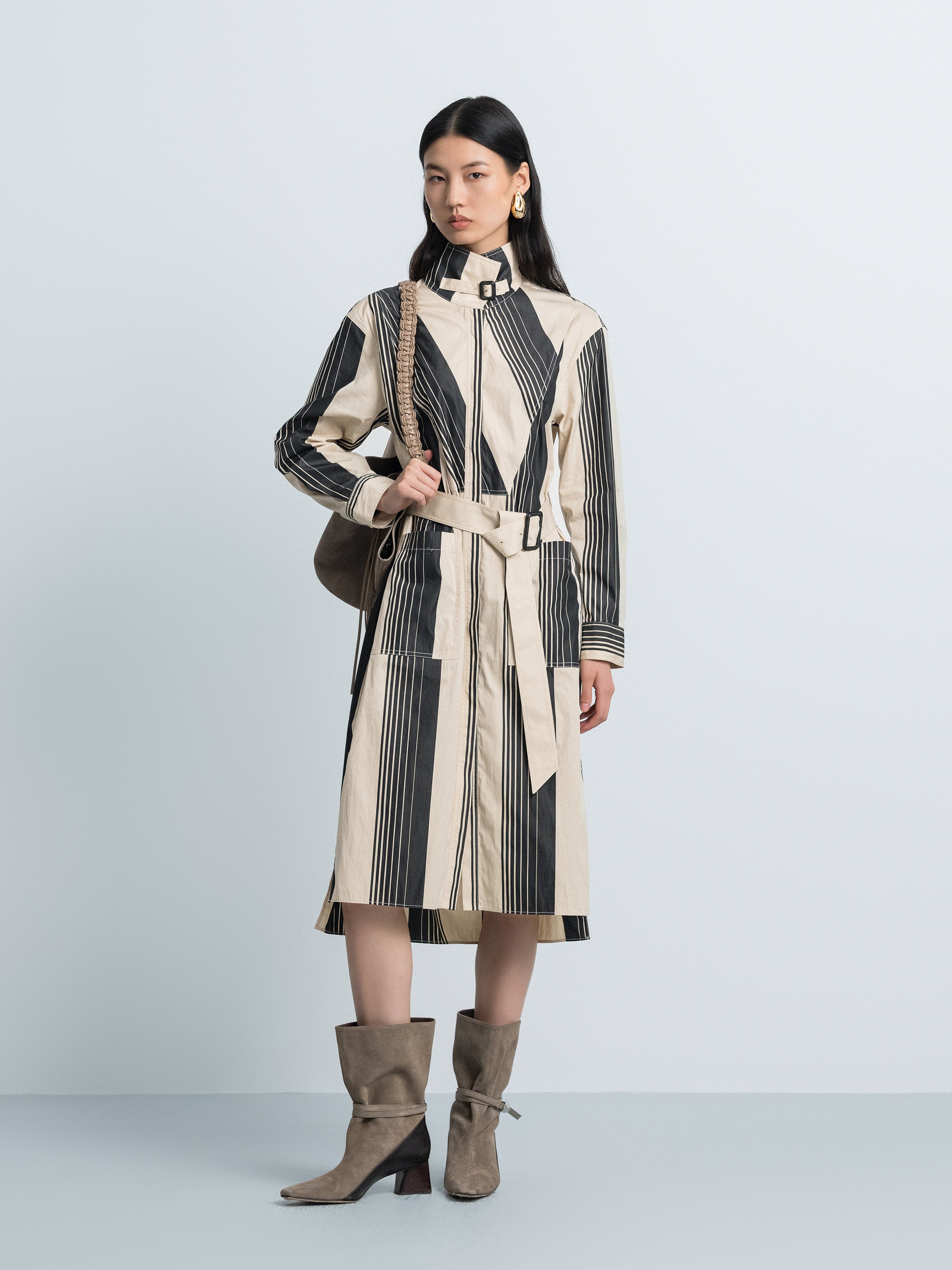 Long striped trench coat with stand collar, belted waist, vertical black and cream panels