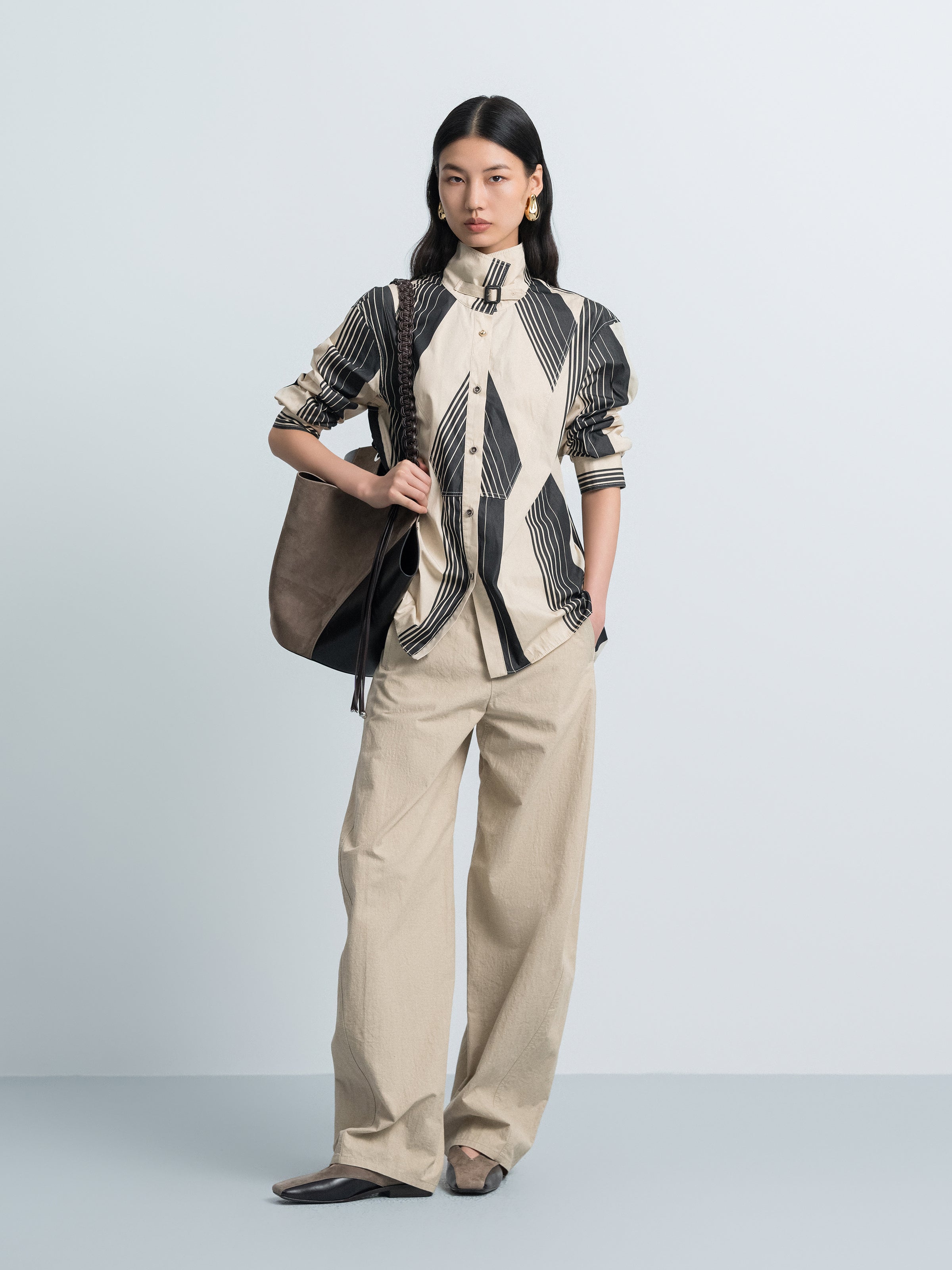 Cream and black striped long-sleeve shirt with button front and stand collar