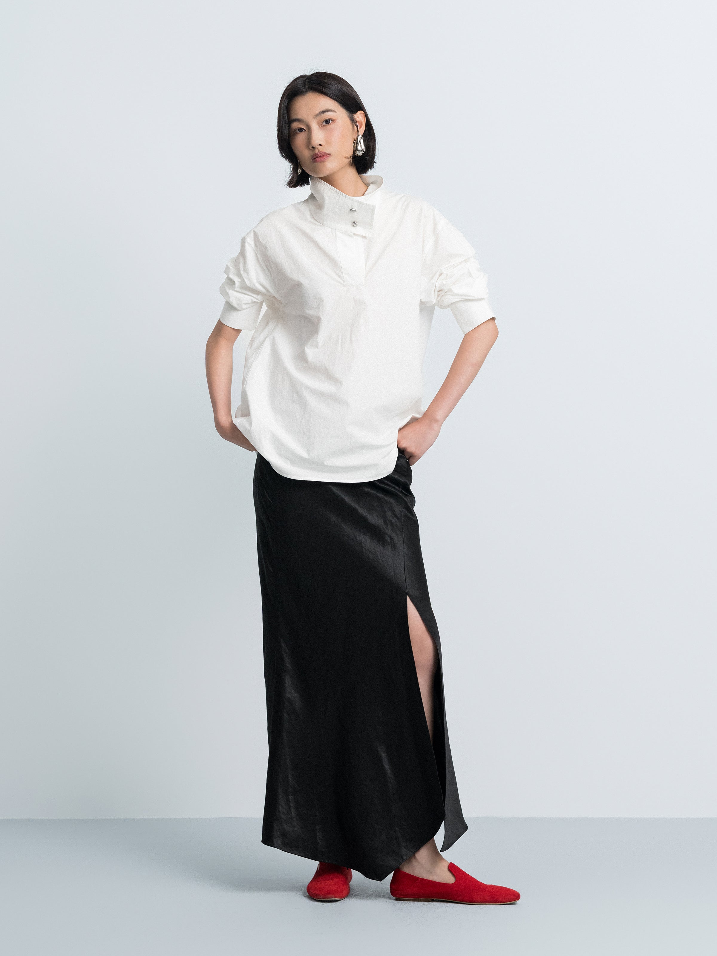 Off-white oversized shirt-style top with stand collar, button front, short puff sleeves