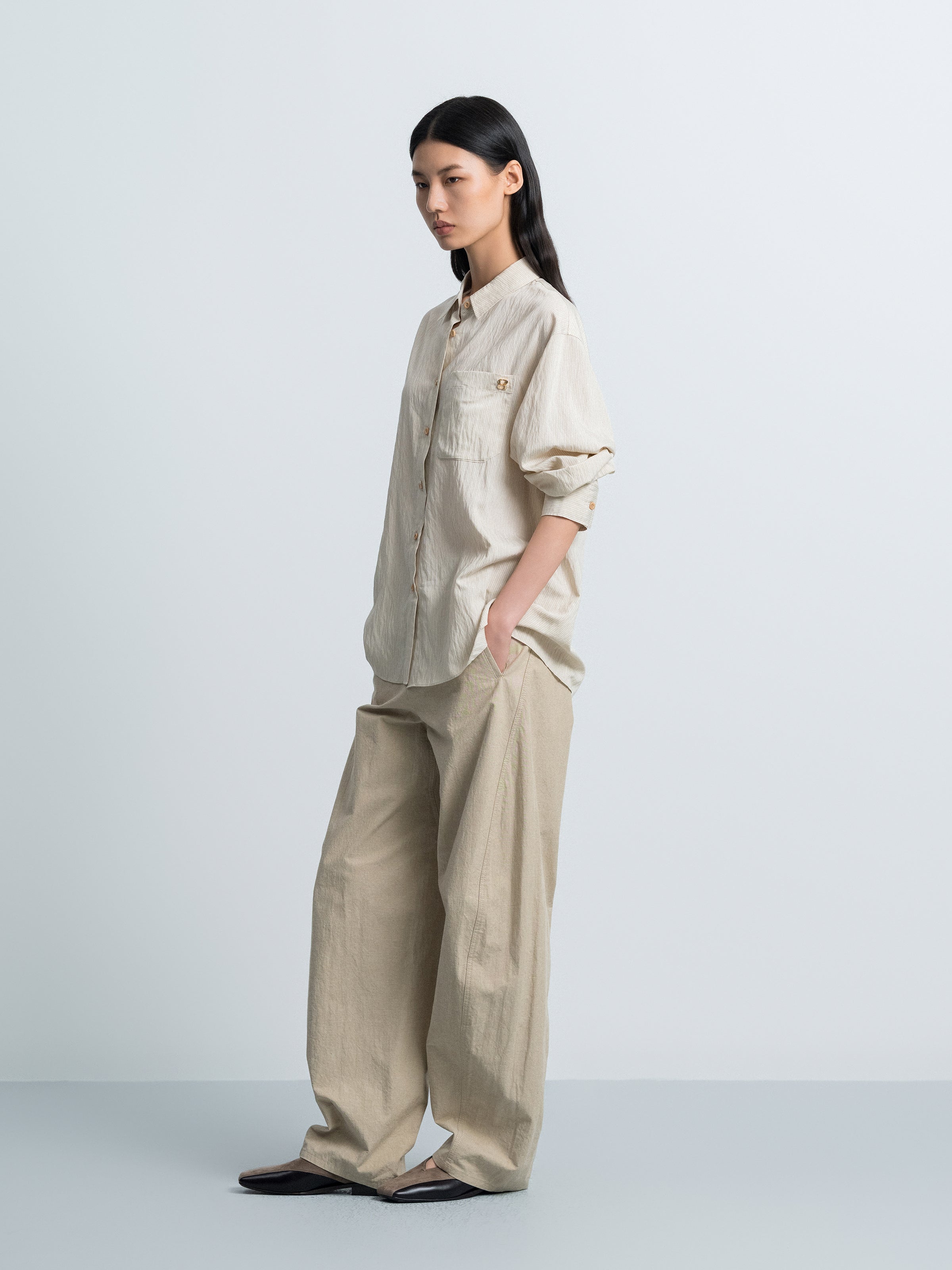 Light beige striped button-up shirt, side view with chest pocket and buttons