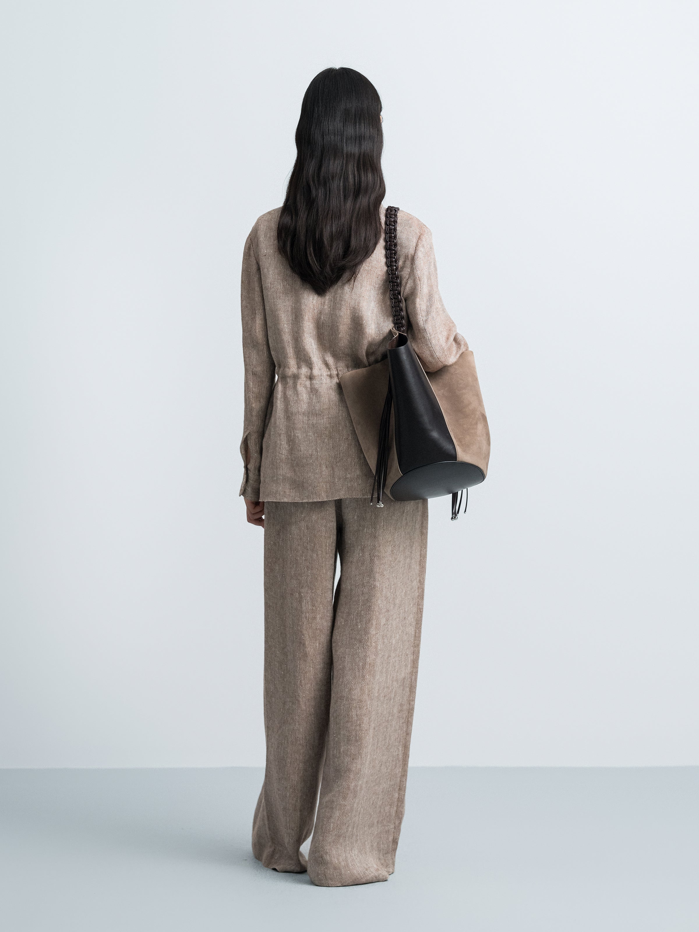 Coffee brown high-waist wide-leg trousers shown from behind with wide legs