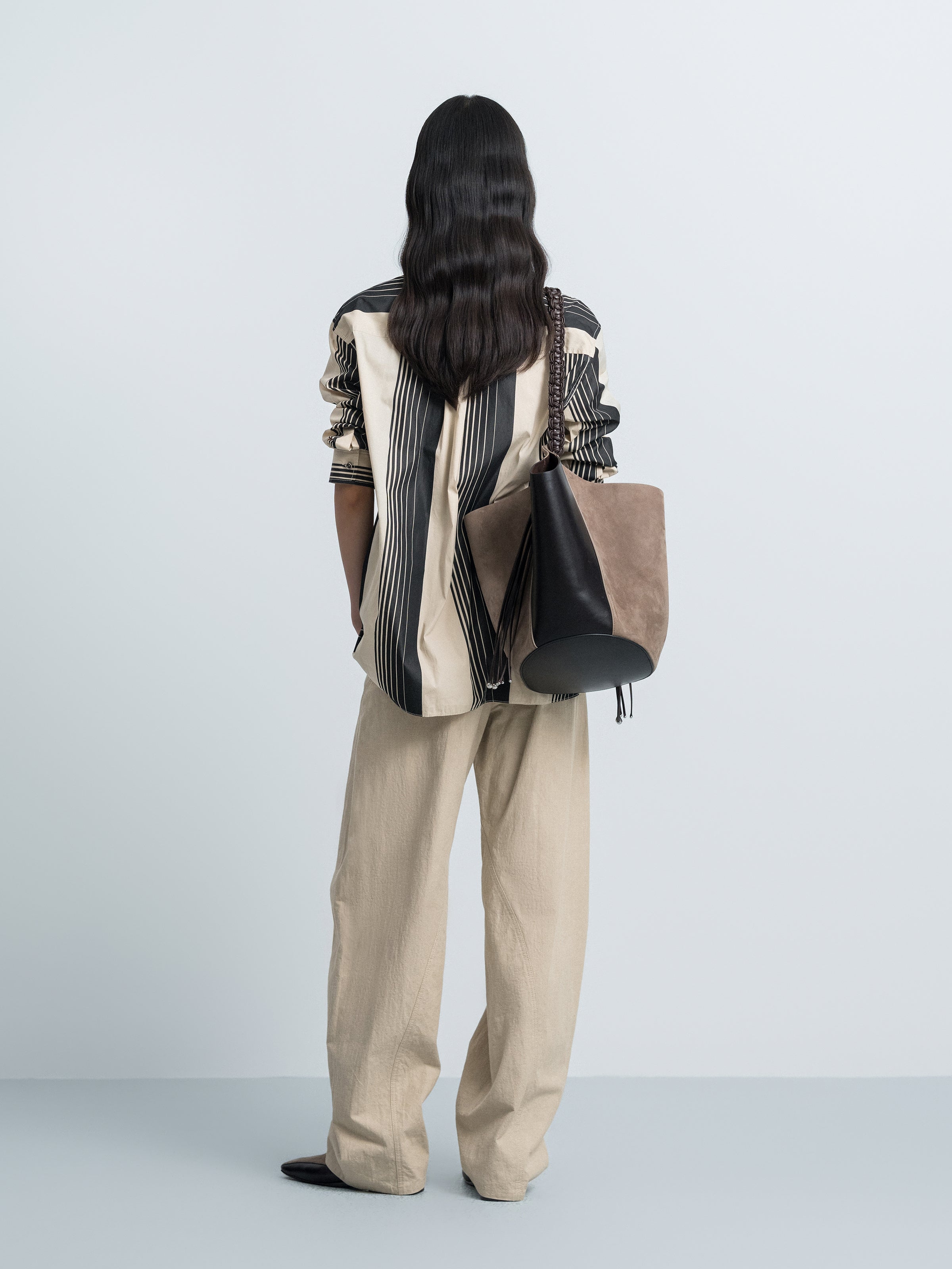 Back view: cream and black striped long-sleeve shirt with stand collar