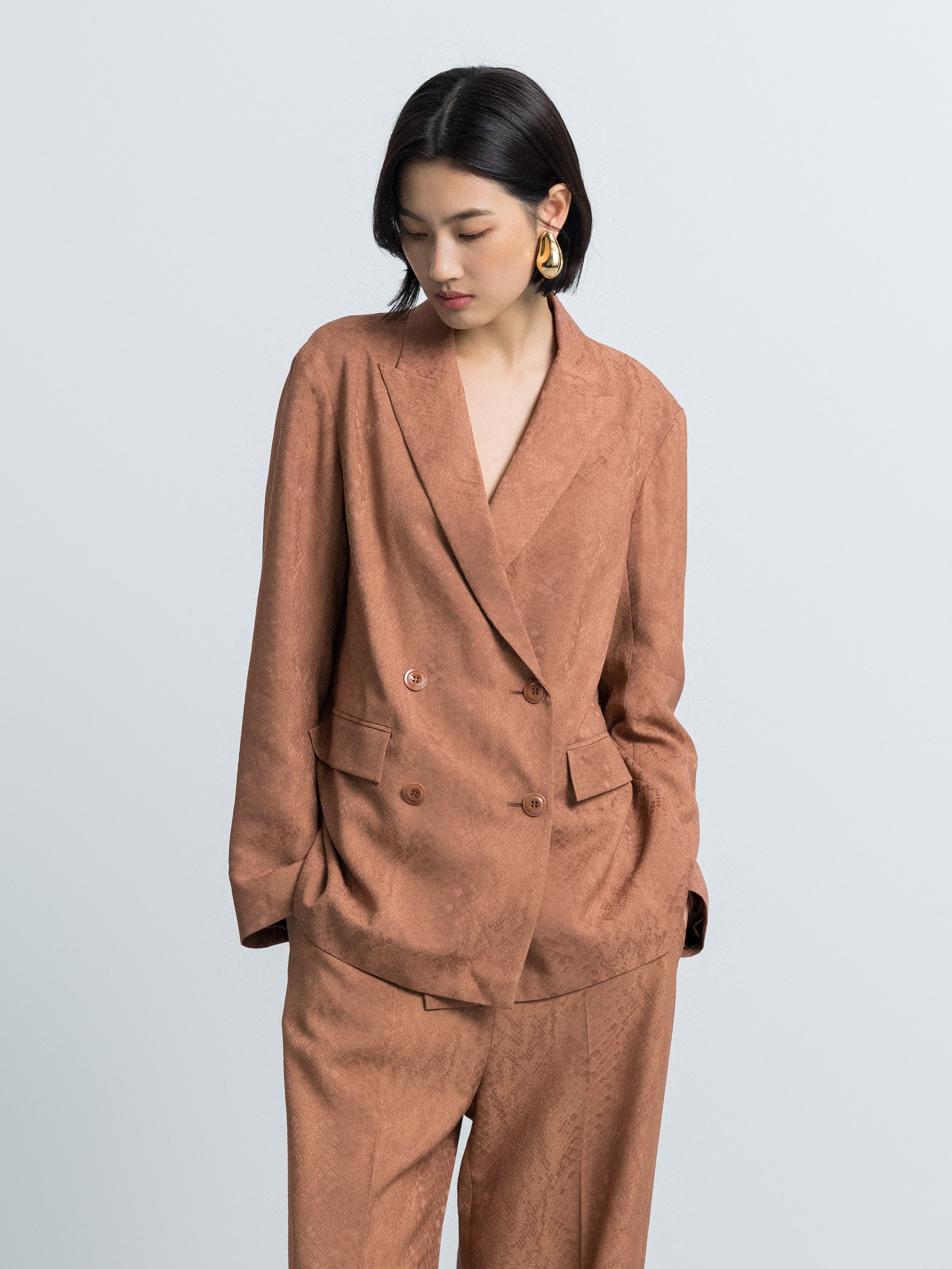 Nude straight-fit blazer front view with notch lapels, two-button closure, flap pockets