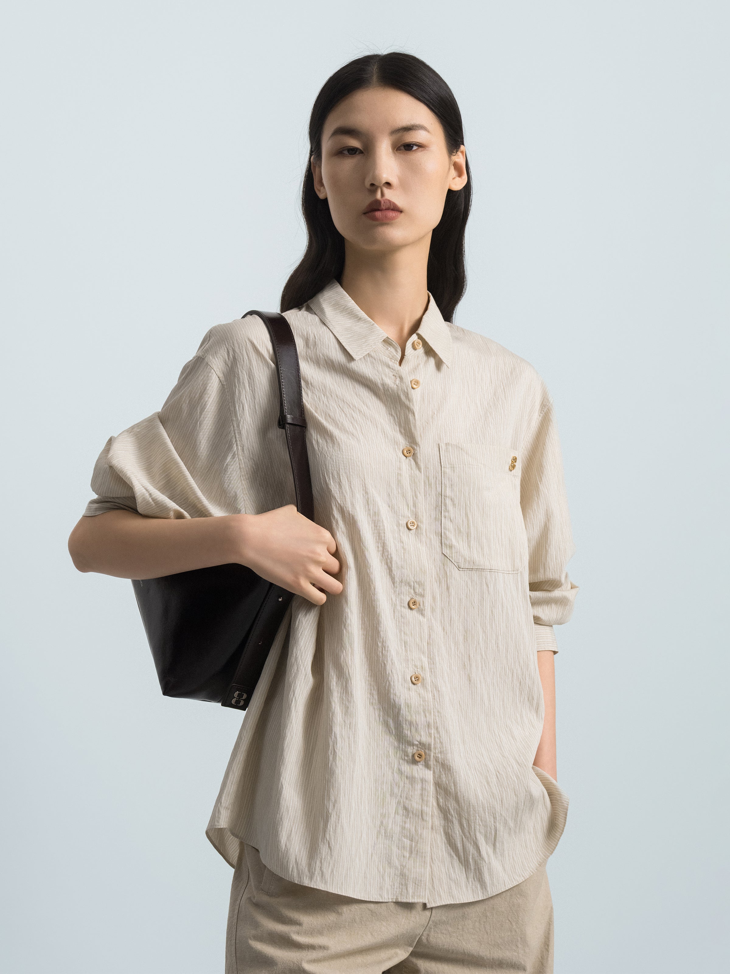 Light beige striped button-up shirt with pointed collar, chest pocket, gold buttons