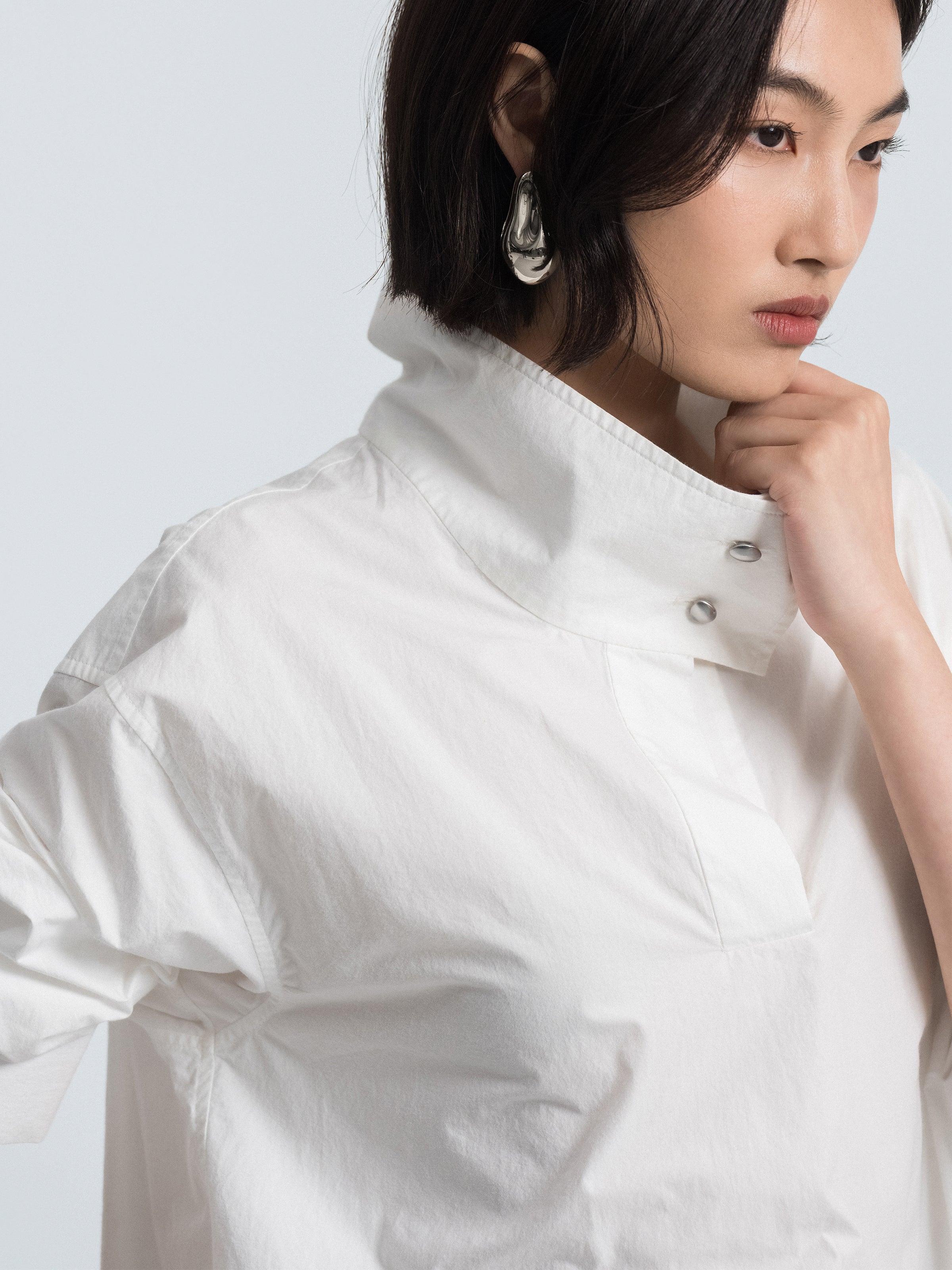 Off-white oversized shirt-style top detail: stand collar and button placket